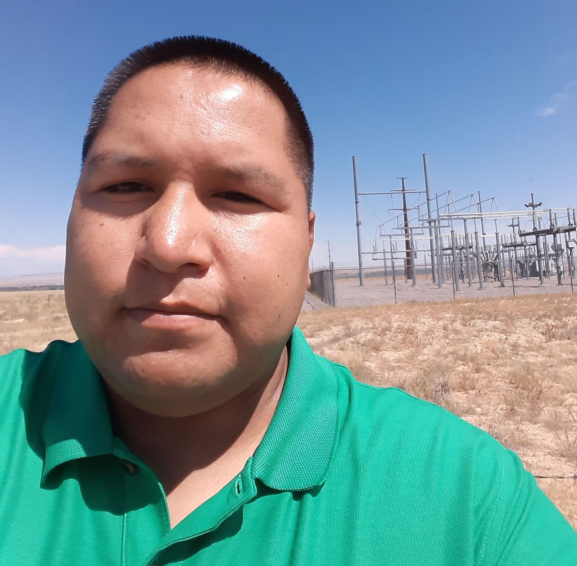 Joseph Hernandez by a transformer substation in his community of Gadii'ahi-To'koi Chapter
